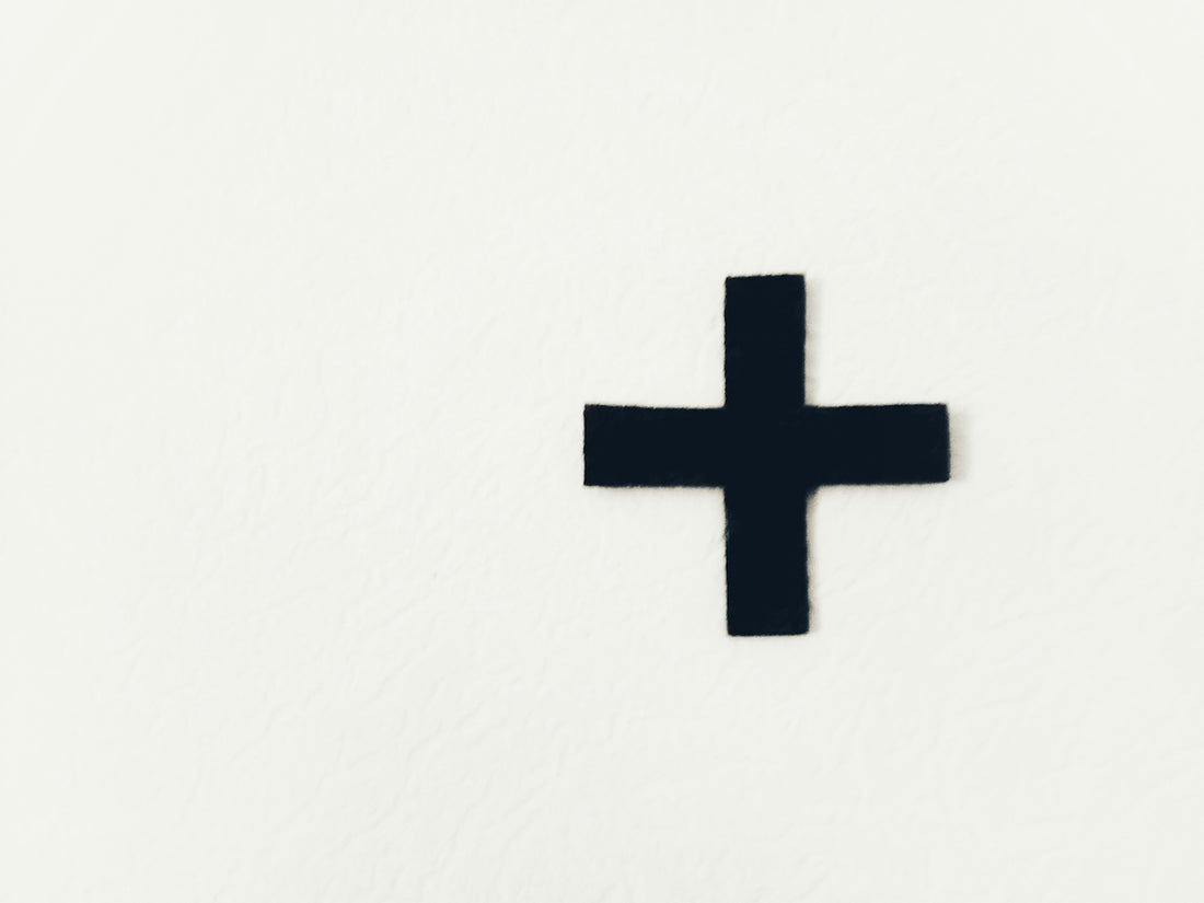 white cross on white background