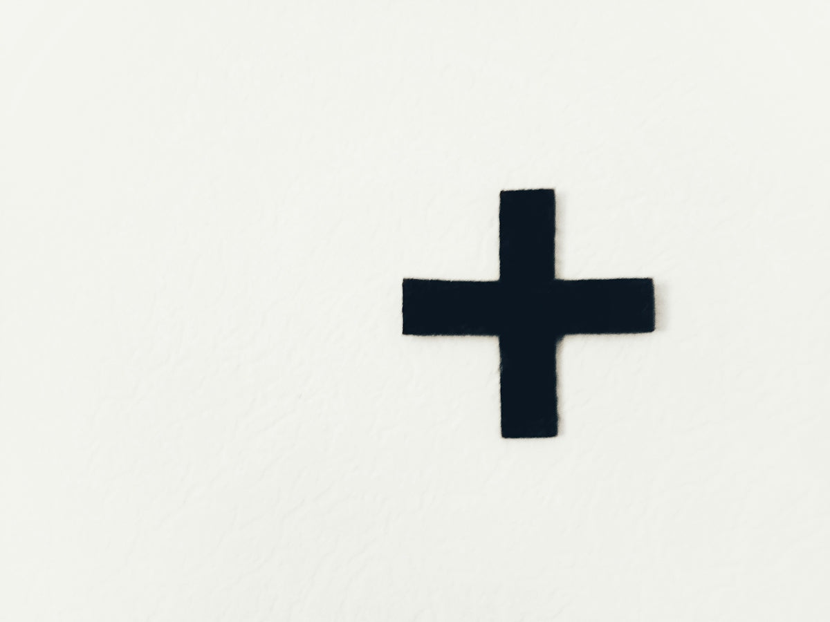 white cross on white background