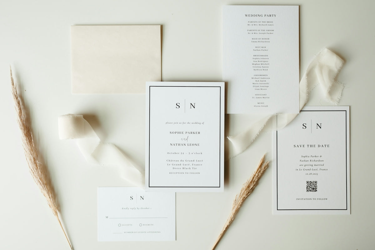 Wedding stationery suite with neutral ribbon and dried flowers